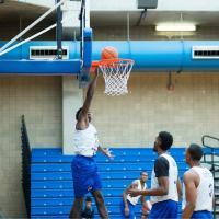 Students playing basketball in gym